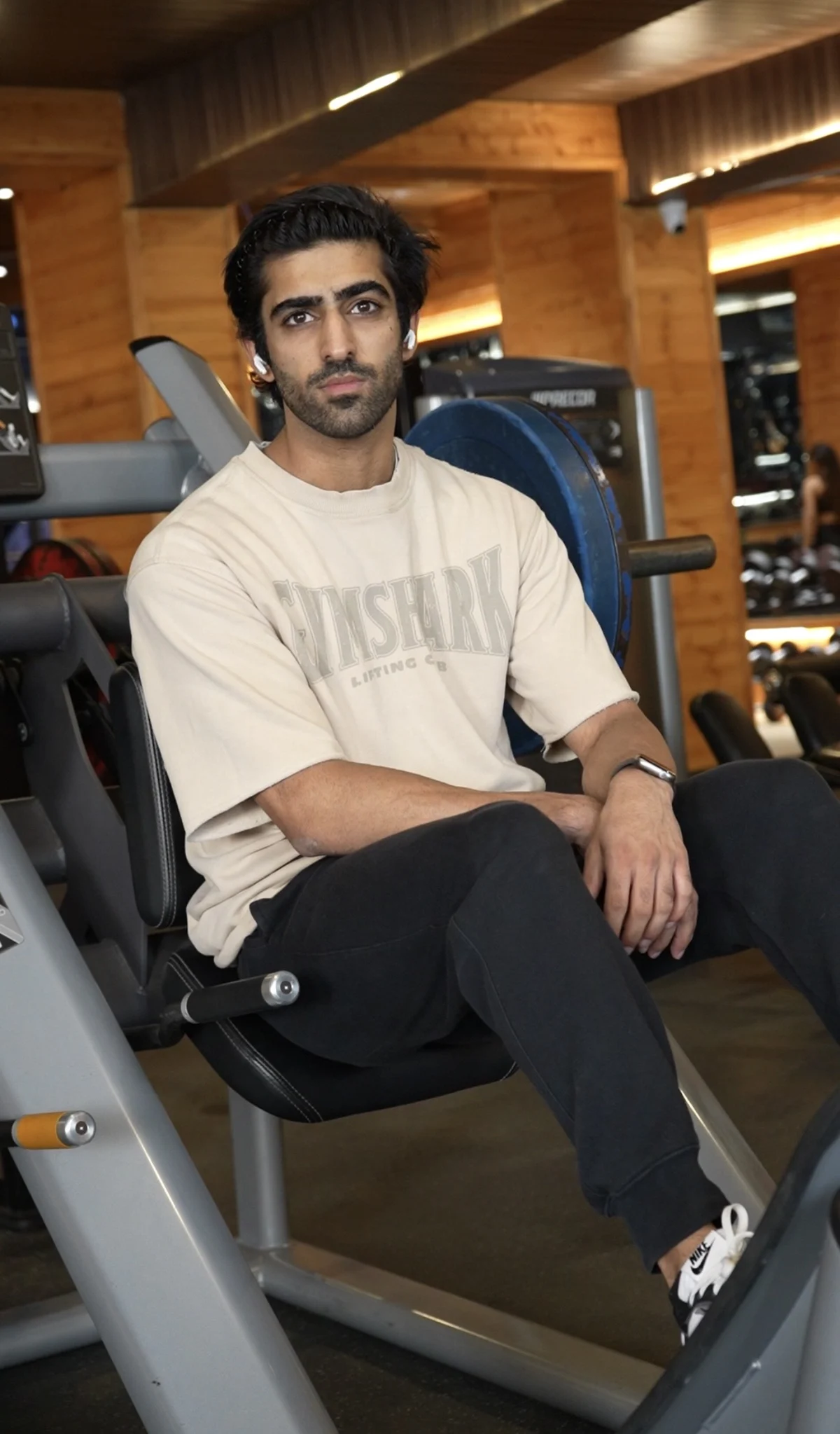 Harshman seated in the gym wearing a cream training shirt